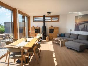 a living room with a table and a couch at Holiday Home Relax Lodge am See by Interhome in Neusiedl am See