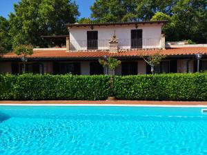 a house with a swimming pool in front of a building at Azienda Agraria Il Cardellino 1 in San Valentino di Villa