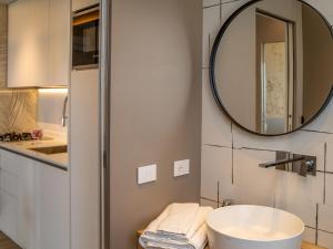 a bathroom with a sink and a mirror at Apartment Mar di Roseto by Interhome in Roseto degli Abruzzi