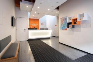 a lobby with a waiting area in a building at easyHotel Rotterdam City Centre in Rotterdam