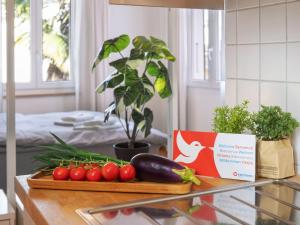 a counter with tomatoes and a cutting board with vegetables at Studio Da Gina Honey Moon Ascona by Interhome in Ascona