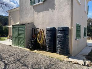 a pile of tires sitting next to a building at U FARNIENTE in Patrimonio