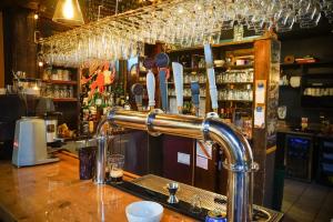 a bar counter with a tap in a bar at Château Logue Hotel in Maniwaki