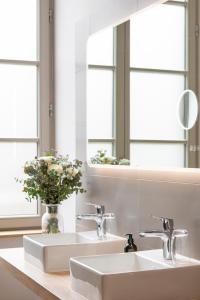 a bathroom with two sinks and a mirror at Domaine et Château de Valinches in Marols