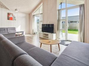 a living room with a couch and a tv at Holiday Home Blaga - all inclusive - 3-3km from the sea by Interhome in Rømø Kirkeby