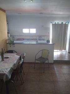 a kitchen with a table and chairs in a room at Queto in Santa Fe