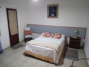 a bedroom with a bed with red pillows on it at Queto in Santa Fe