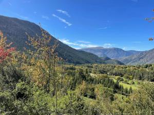 a view of a valley with trees and mountains at Maison Gaia in Valdeblore