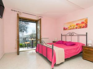 ein Schlafzimmer mit einem Bett und einem Balkon in der Unterkunft Holiday Home Candy-3 by Interhome in Nerano