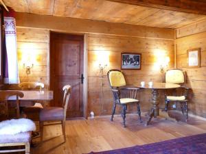a room with a wooden wall with a table and chairs at Apartment Les Moulins by Interhome in Verbier