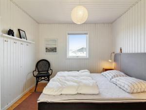 a bedroom with a large white bed with a window at Holiday Home Carstina - all inclusive - 400m from the sea by Interhome in Skagen