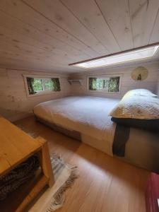 a large bed in a room with two windows at Cliffside Hideaways 