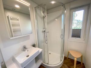 a bathroom with a sink and a shower at Holiday Home Tiny Haus Auszeit by Interhome in Riedenburg