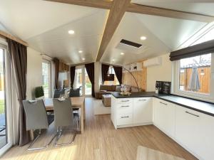a kitchen and dining room of a caravan with a table and chairs at Holiday Home Tiny Haus ChrisTine by Interhome in Riedenburg