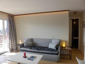 a living room with a couch and a table at Apartment Elysée by Interhome in Crans-Montana