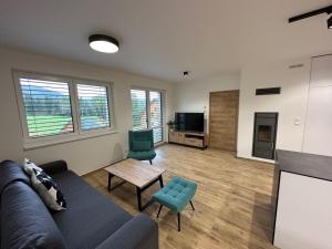 uma sala de estar com um sofá e uma mesa em Apartment Chalupa 13ka - Dolní apartmán by Interhome em Smržovka