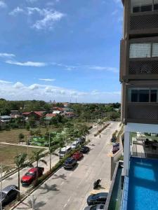 a view of a street with cars parked in a parking lot at Condotel810byWVtowers1&2 in Iloilo City