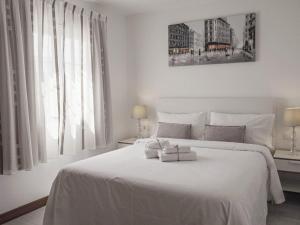 a bedroom with a white bed with two towels on it at Villa Villa Marina by Interhome in Playa Blanca