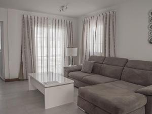 a living room with a couch and a coffee table at Villa Villa Marina by Interhome in Playa Blanca