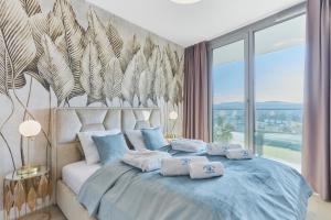 Postel nebo postele na pokoji v ubytování Wave Resort&SPA - Blue Shell Apartment + 34 fotografií