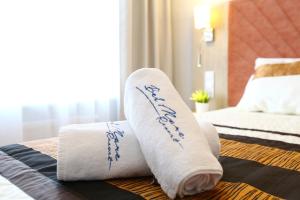 a pair of towels on a bed in a hotel room at Sunny Haven Bel Mare Parking, Basen FREE in Międzyzdroje