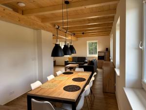 a dining room and living room with a wooden table and chairs at Apartment Chalupa 13ka - Horní apartmán by Interhome in Smržovka +28 photos