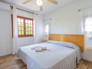 a bedroom with a bed with two towels on it at Apartment Son Bou Gardens PLUS by Interhome in Son Bou