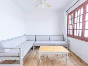 a living room with a white couch and a table at Apartment Son Bou Gardens PLUS by Interhome in Son Bou