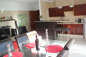 a glass table with a bottle of wine on it in a kitchen at Dream Holidays with See View - Praia Rocha in Portimão