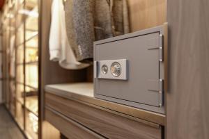 a safe in a closet with a wooden door at Plaza de España Boutique Apartment in Nerja