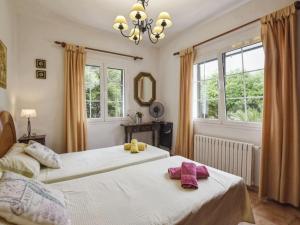 two beds in a bedroom with two stuffed animals on them at Villa Tortolas by Interhome in Alaior