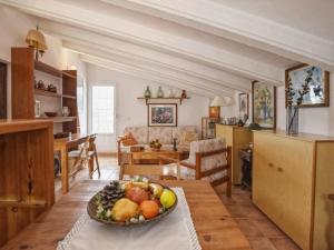 a kitchen and living room with a bowl of fruit on a table at Villa Tortolas by Interhome in Alaior