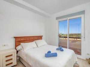 ein Schlafzimmer mit einem Bett mit blauen Handtüchern darauf in der Unterkunft Apartment Casares del Sol by Interhome in Casares