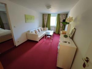 een woonkamer met een bank en een tafel bij Room in Guest room - Pension Forelle - double room in Forbach