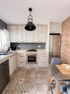 a kitchen with a refrigerator and a table in it at Beach House Málaga in Málaga