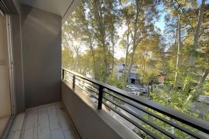 a balcony with a large window with a view of trees at Estudio Ejecutivo con Amenities in Rosario