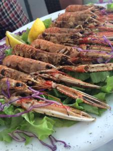 a plate of food with lobsters and a salad at Appartement BM in Drage +5 photos
