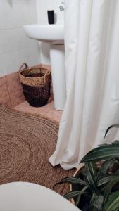 a bathroom with a sink and a white shower curtain at Plakourakia in Finikas