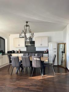 a kitchen with a dining room table and chairs at Top Hill Balaton in Badacsonytomaj