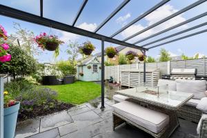 a patio with a glassconservatory with a table at Modern Clonsilla Townhouse Sleeps 6 in Dublin