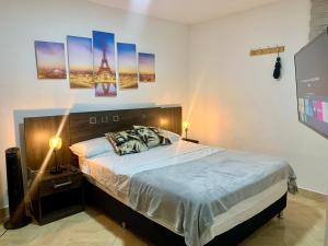 - une chambre avec un grand lit et une télévision dans l'établissement 13 Sabaneta, apartment, Parking, Pool & with club in the sky!, à Sabaneta