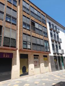 a building on a street with a man in front of it at Bardenas de Tudela in Tudela