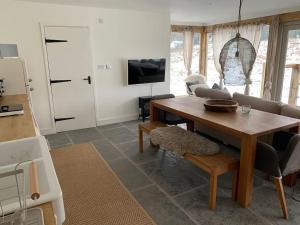 a living room with a table and a couch at Guest Homes - The Potting Shed in Worcester