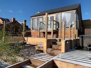 a house being constructed with wooden steps and windows at Guest Homes - The Potting Shed in Worcester