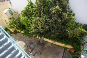 an overhead view of a patio with chairs and a bush at Archontiko Pataka in Rhodes Town