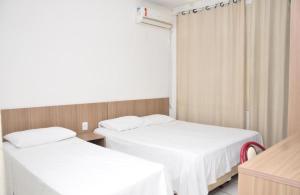 Katil atau katil-katil dalam bilik di Hotel Manoá Poa