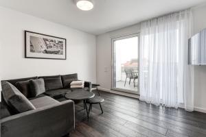 a living room with a couch and a table at Haus Noena in Norderney