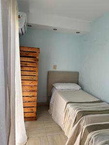 a bedroom with two beds and a wooden dresser at Ahicito - Casa en Tres Cerritos in Salta
