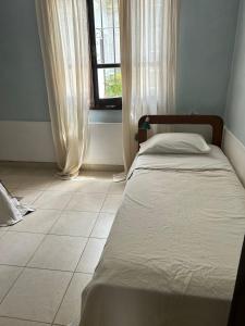 a bed in a room with a window at Ahicito - Casa en Tres Cerritos in Salta