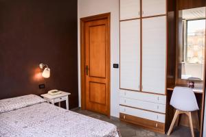 a bedroom with a bed and a table and a window at Albergo Florida Taggia in Taggia